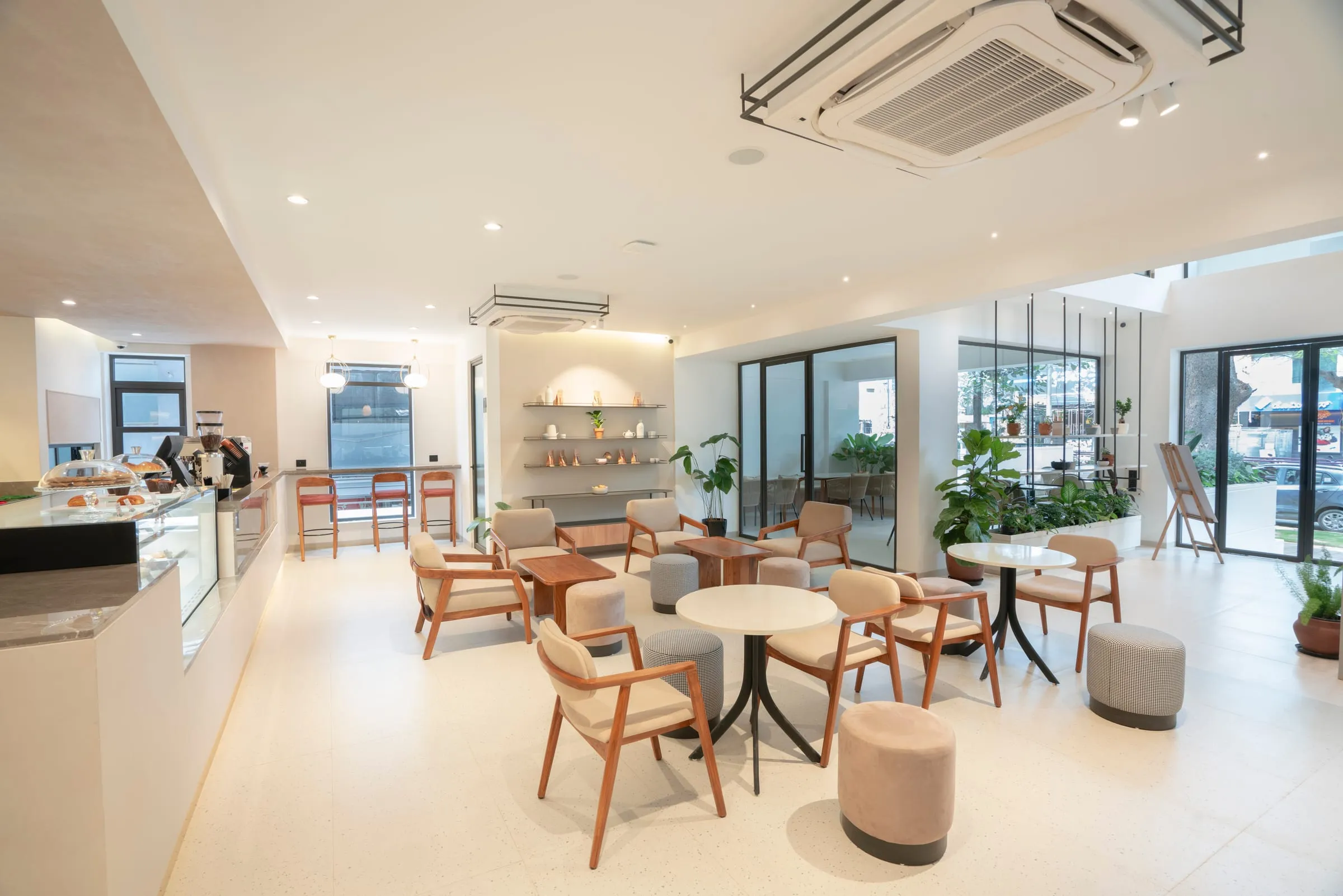 The bright Paper & Pie café in Indiranagar: pale wood chairs, a bar counter and plants