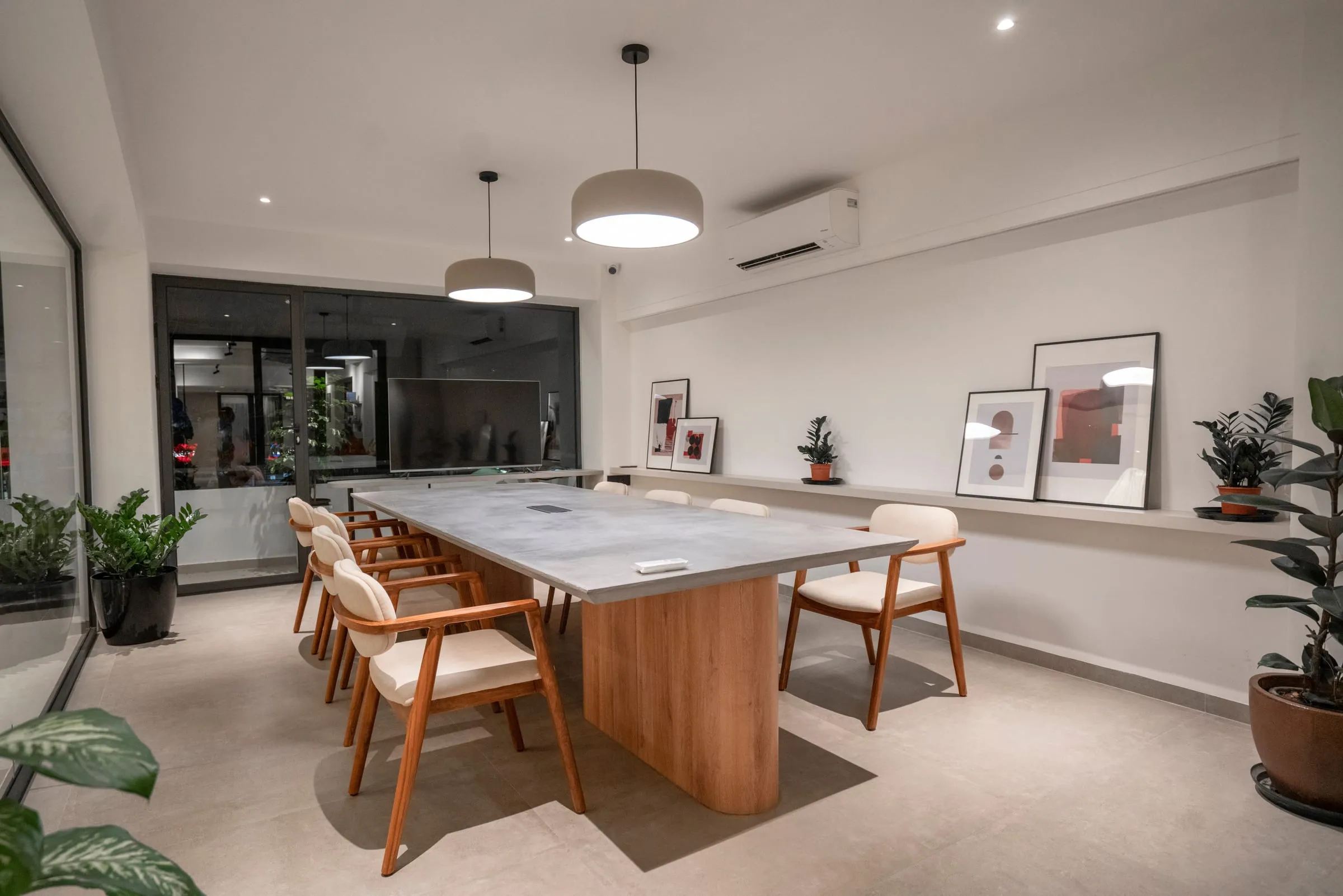 The Paper & Pie conference room: a long table, pendant lights and framed prints